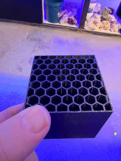 Top view of the Reef Secrets Mysid Shrimp Hotel, black 3D printed PETG block with open hexagonal honeycomb cells